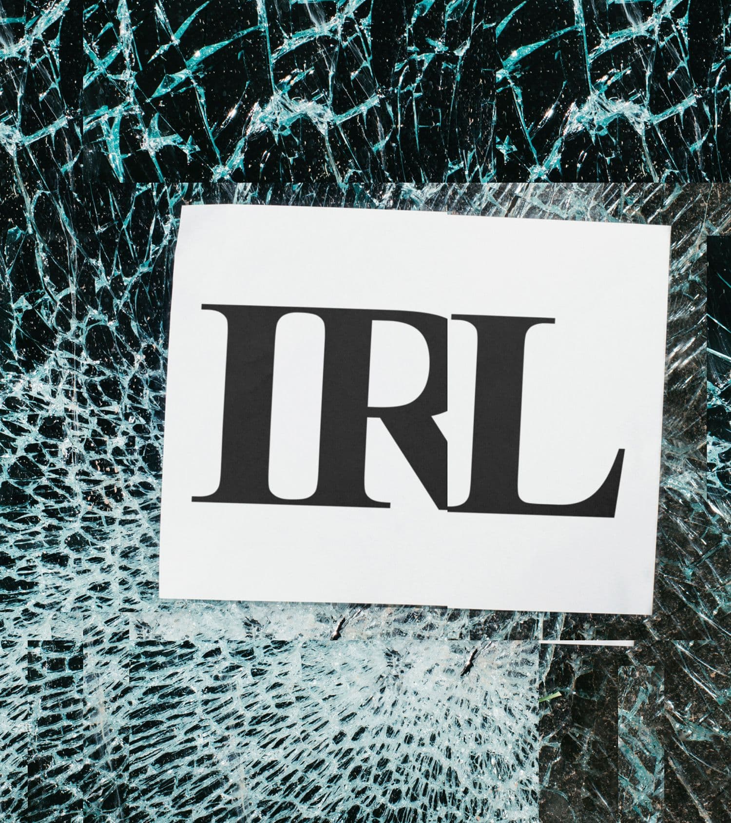 White card printed with IRL on shattered turquoise glass