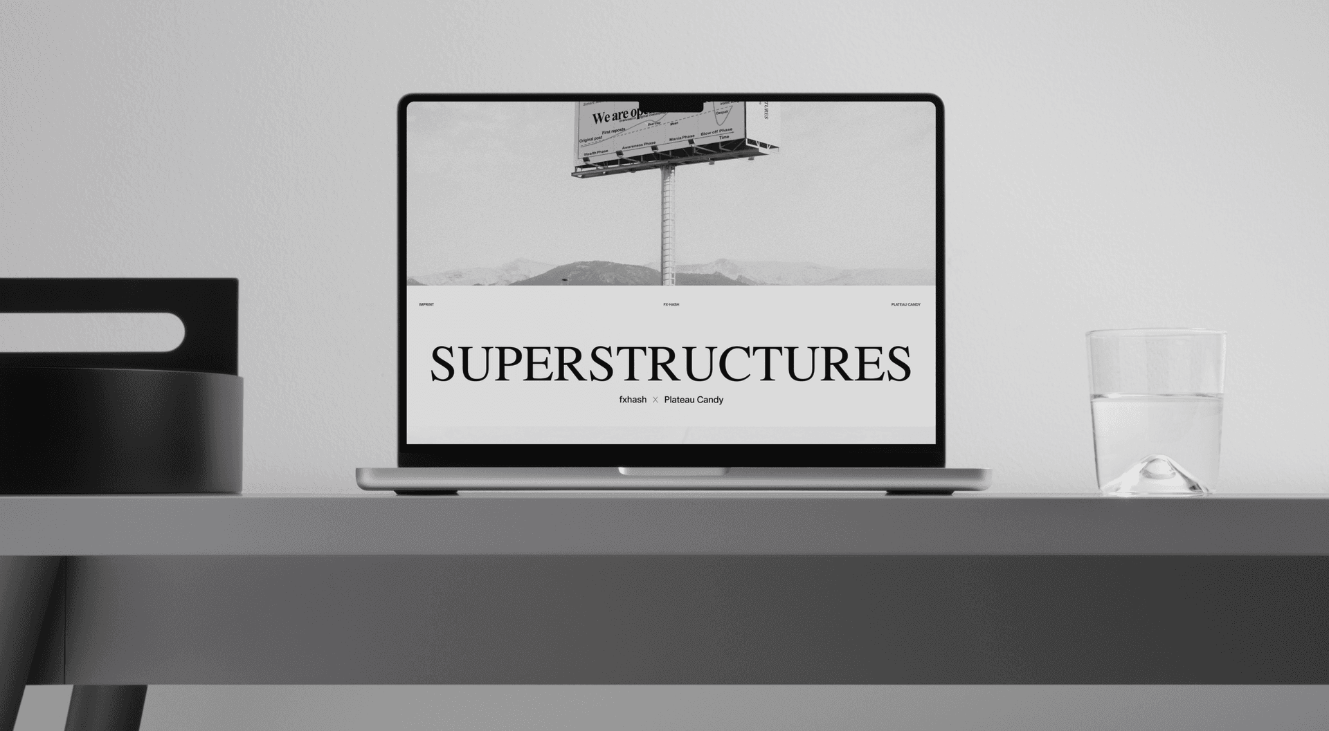 Laptop on a minimal desk displaying the Superstructures website