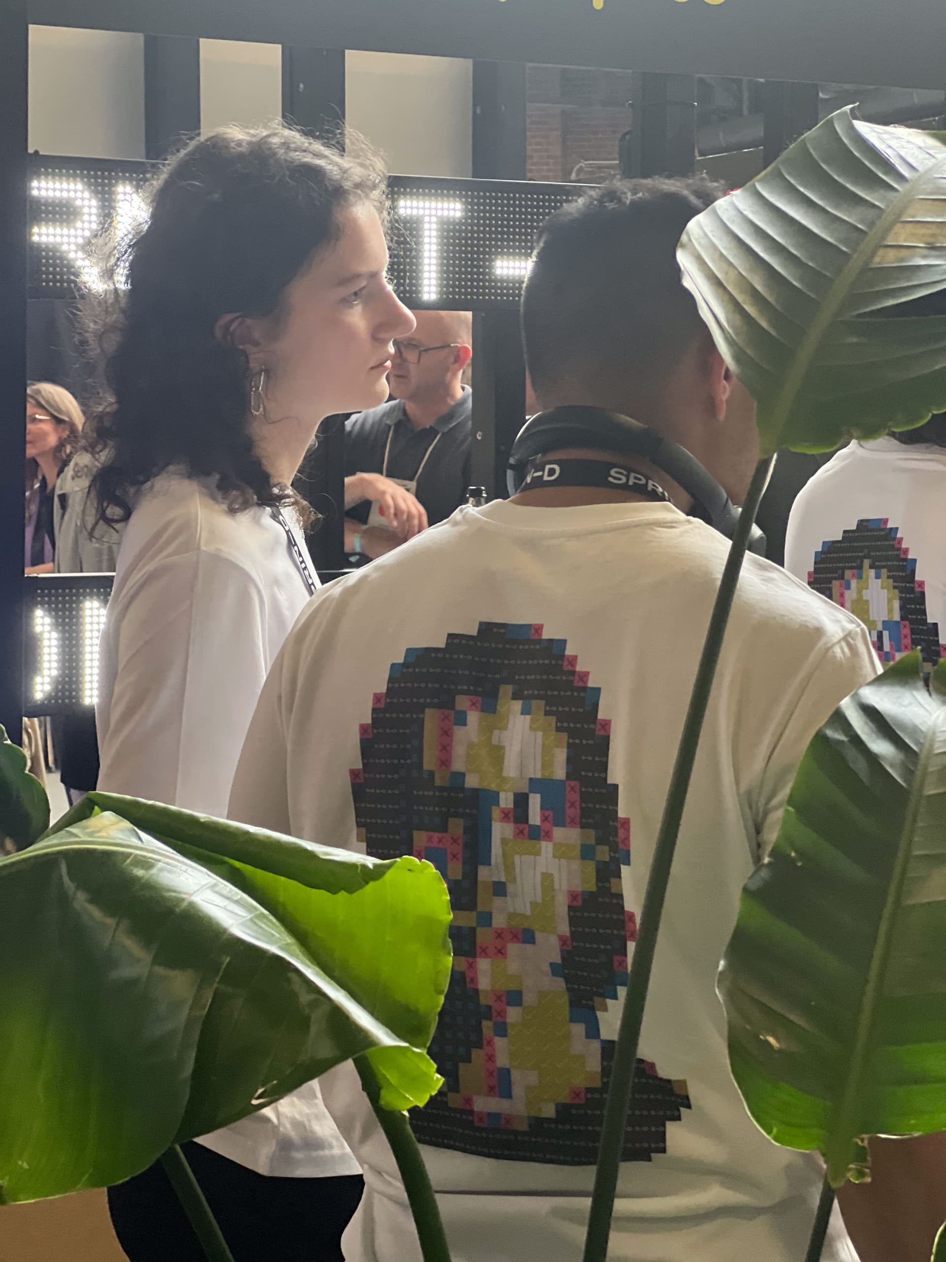 Visitors interacting with the Identity Mirror installation at a fair